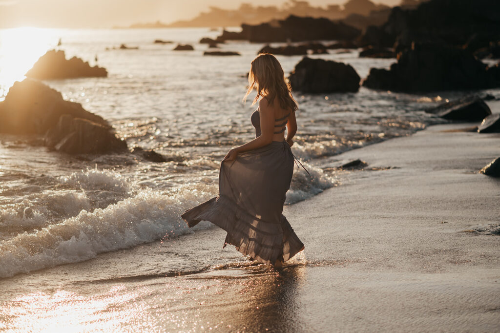 Girl dancing at the shore in Pacific Grove at sunrise - senior session.