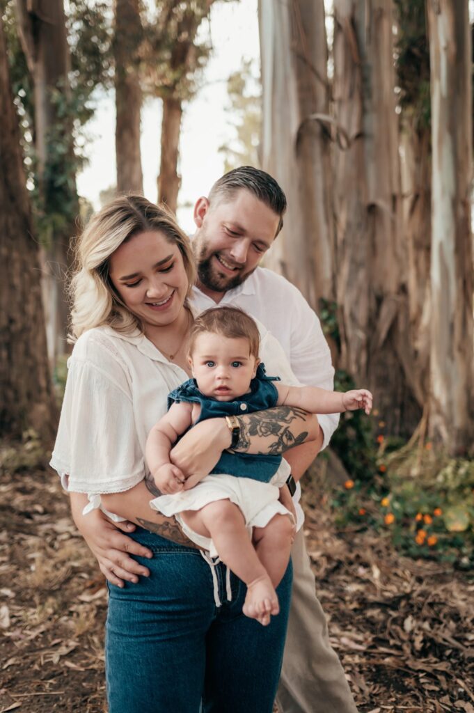 Family with their baby among the eucalyptus trees at Moran Lake in Santa Cruz