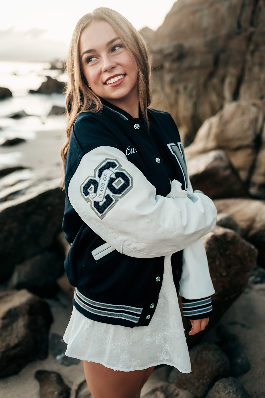Senior looking over her shoulder showing the Class of 2026 patch on her letterman jacket sleeve