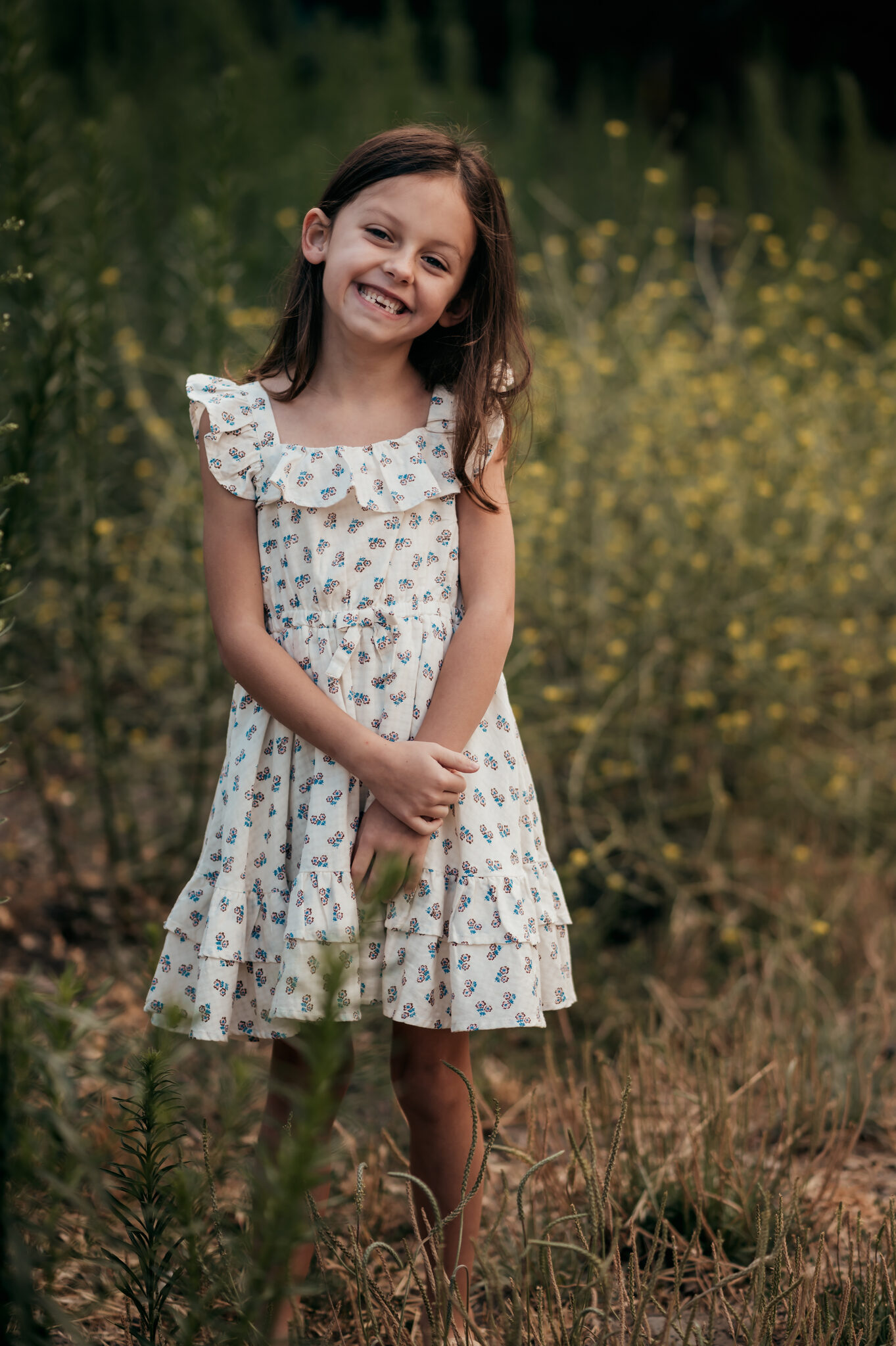 Girl smiling in wildflowers during a Monterey family photo session