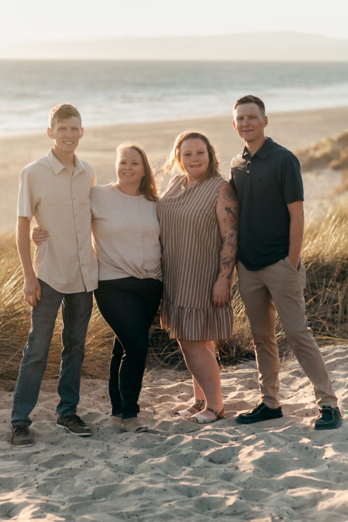 Mom with her three grown kids on the dunes at golden hour