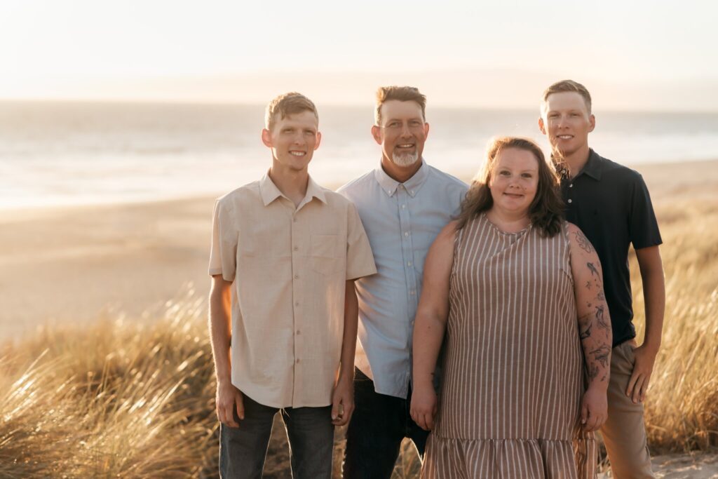Dad with his kids standing on the dunes at Pajaro Dunes in golden light