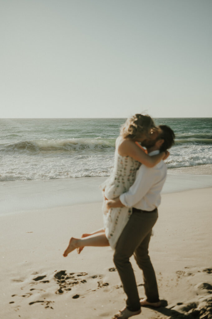 Nick spinning Patrycja around barefoot on the beach at Garrapata State Park